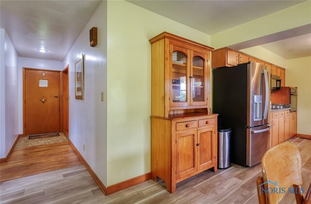 2534 Blanchard Ave, Findlay, OH 45840 - kitchen with black appliances, light wood-style floors, baseboards, and glass insert cabinets