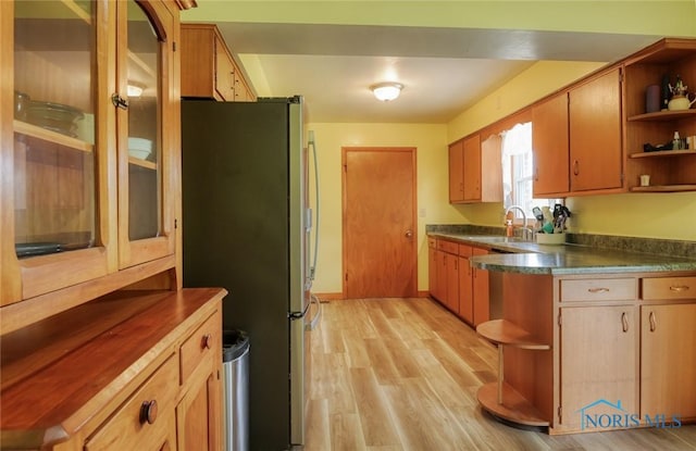 2534 Blanchard Ave, Findlay, OH 45840 - kitchen featuring open shelves, freestanding refrigerator, a sink, light wood-style floors, and dark countertops