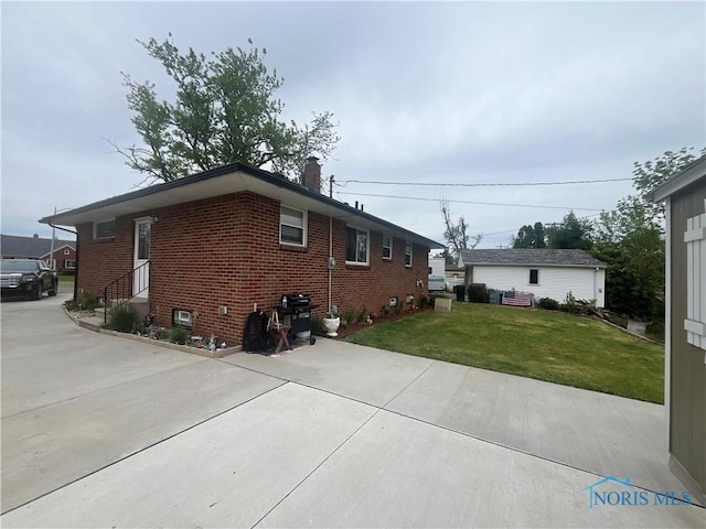 4448 Helmond Ct, Toledo, OH 43611 - view of side of home with brick siding and a yard