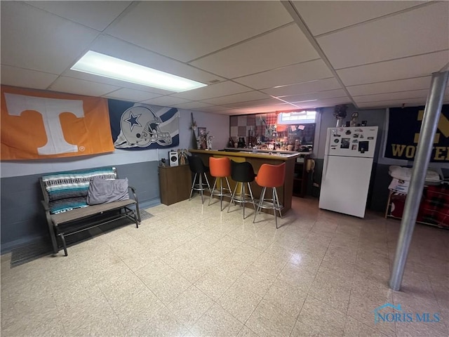 4448 Helmond Ct, Toledo, OH 43611 - indoor dry bar with freestanding refrigerator, a paneled ceiling, and tile patterned floors