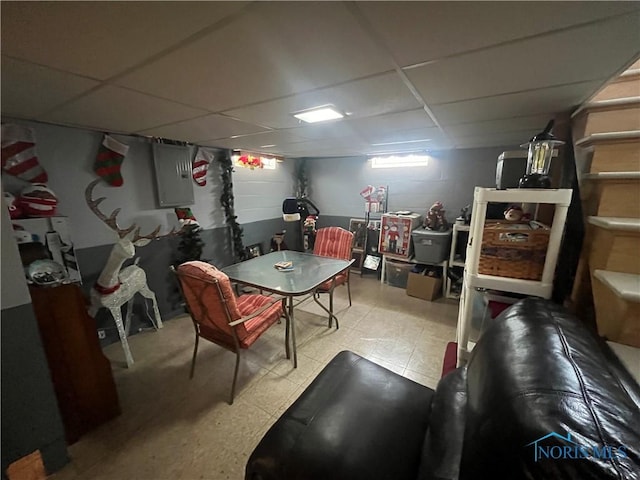 4448 Helmond Ct, Toledo, OH 43611 - recreation room with a paneled ceiling, electric panel, concrete block wall, and tile patterned floors
