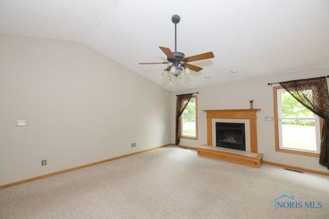 1033 Joseph Rd, Luckey, OH 43443 - unfurnished living room with lofted ceiling, baseboards, a fireplace with raised hearth, carpet floors, and a ceiling fan