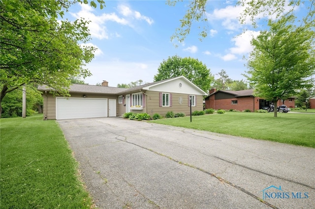1 Hawthorne Dr, Delta, OH 43515 - single story home with a garage, driveway, a front yard, and a chimney