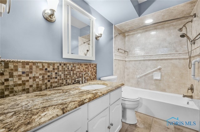 1 Hawthorne Dr, Delta, OH 43515 - bathroom featuring toilet, washtub / shower combination, tasteful backsplash, vanity, and tile patterned floors