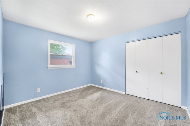1 Hawthorne Dr, Delta, OH 43515 - unfurnished bedroom with carpet flooring, baseboards, and a closet