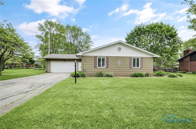 1 Hawthorne Dr, Delta, OH 43515 - single story home featuring driveway, an attached garage, and a front yard