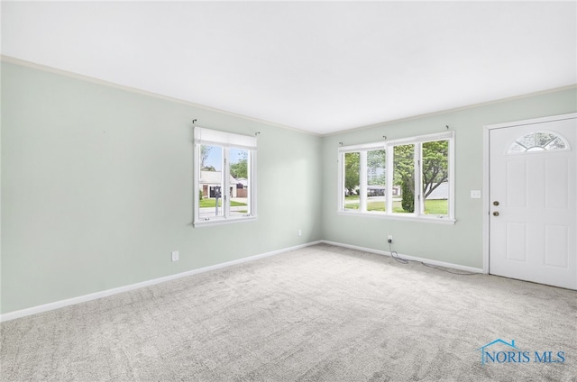 1 Hawthorne Dr, Delta, OH 43515 - carpeted foyer entrance featuring baseboards and crown molding