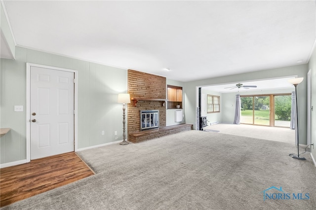 1 Hawthorne Dr, Delta, OH 43515 - unfurnished living room featuring carpet, a fireplace, ceiling fan, and baseboards