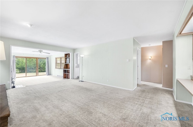 1 Hawthorne Dr, Delta, OH 43515 - unfurnished living room featuring a ceiling fan, carpet, and baseboards