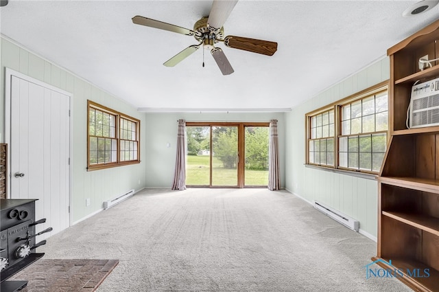1 Hawthorne Dr, Delta, OH 43515 - unfurnished living room with baseboard heating, carpet flooring, and a ceiling fan