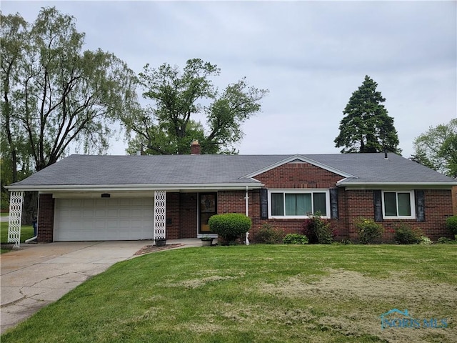 3434 Muirfield Ave, Toledo, OH 43614 - ranch-style home with an attached garage, driveway, and brick siding