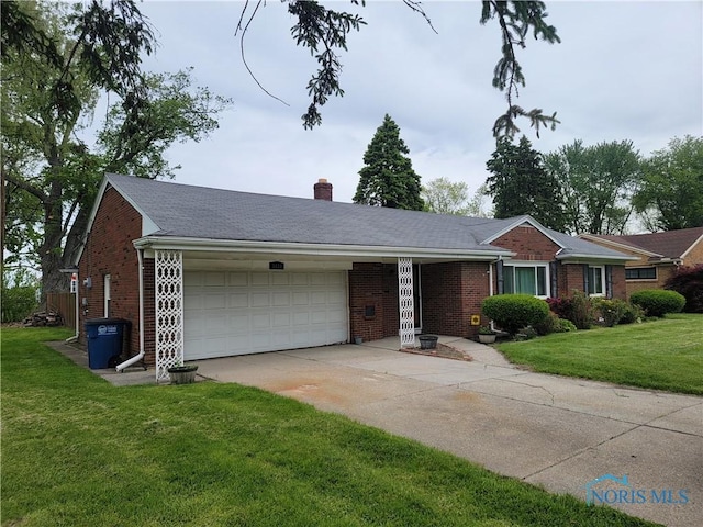 3434 Muirfield Ave, Toledo, OH 43614 - single story home with an attached garage, driveway, brick siding, a front lawn, and a chimney