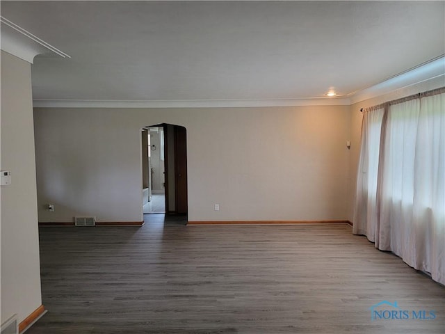 3434 Muirfield Ave, Toledo, OH 43614 - spare room with crown molding, baseboards, wood finished floors, and arched walkways