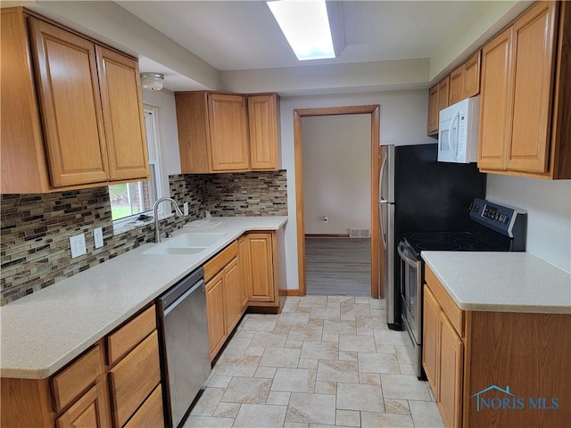 3434 Muirfield Ave, Toledo, OH 43614 - kitchen with stainless steel appliances, a sink, backsplash, and light countertops