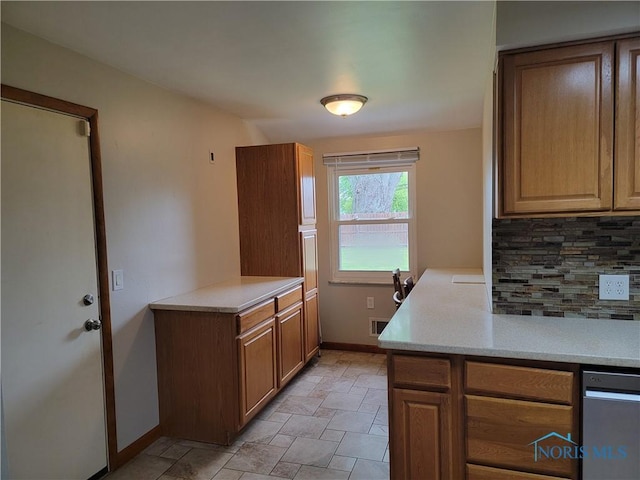 3434 Muirfield Ave, Toledo, OH 43614 - kitchen featuring tasteful backsplash, stone finish flooring, baseboards, light countertops, and dishwasher