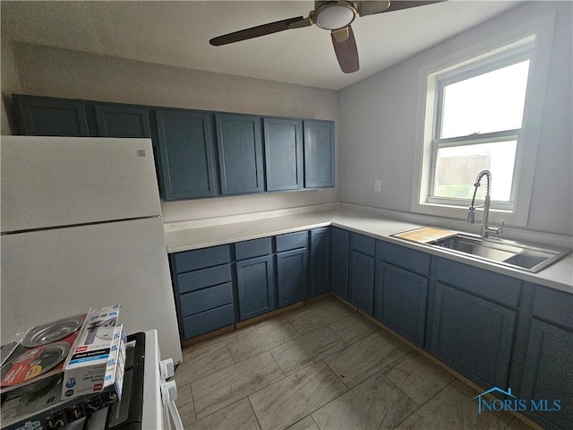 1545 Buckingham St, Toledo, OH 43607 - kitchen featuring freestanding refrigerator, ceiling fan, a sink, and light countertops