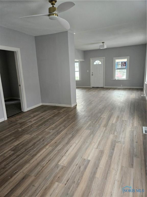 1545 Buckingham St, Toledo, OH 43607 - unfurnished living room with a ceiling fan, plenty of natural light, baseboards, and wood finished floors
