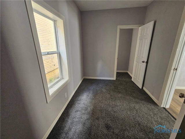 1545 Buckingham St, Toledo, OH 43607 - unfurnished room featuring dark carpet and baseboards