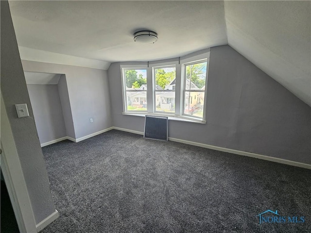 1545 Buckingham St, Toledo, OH 43607 - bonus room with lofted ceiling, dark colored carpet, and baseboards