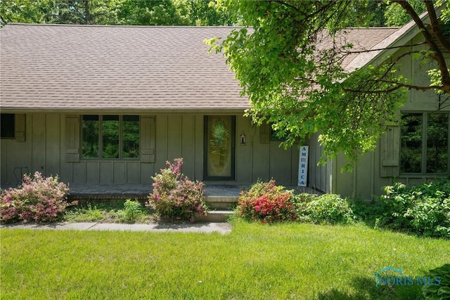 12949 Shaffer Rd, Swanton, OH 43558 - view of front of property with roof with shingles, board and batten siding, covered porch, and a front yard