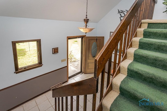12949 Shaffer Rd, Swanton, OH 43558 - entrance foyer with light tile patterned floors, stairs, healthy amount of natural light, and vaulted ceiling