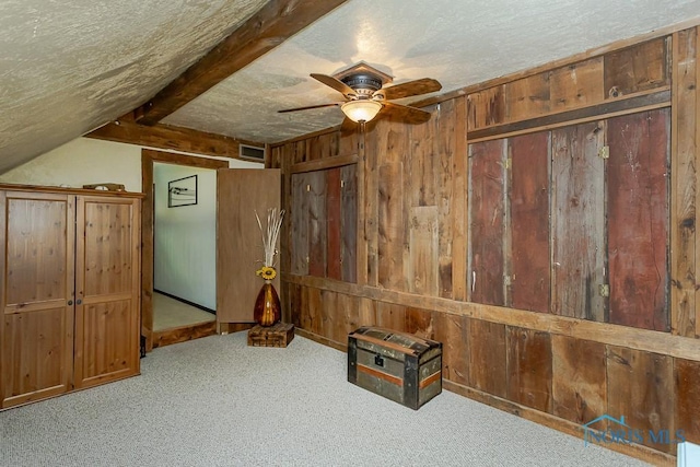 12949 Shaffer Rd, Swanton, OH 43558 - detailed view of wood walls, a ceiling fan, a textured ceiling, and carpet floors