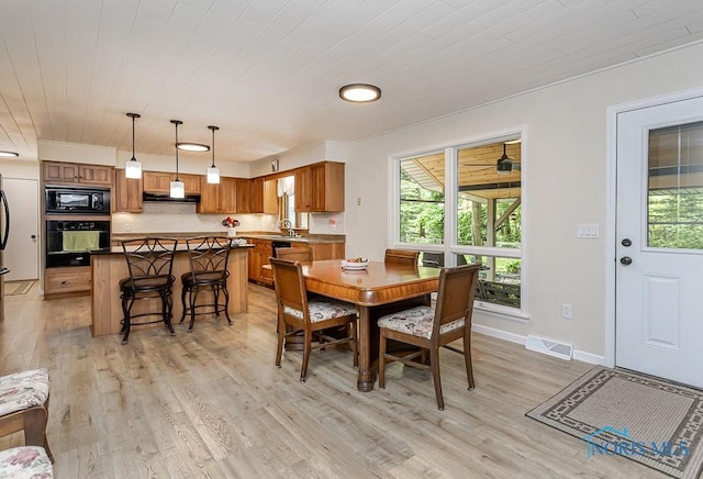 12949 Shaffer Rd, Swanton, OH 43558 - dining area featuring healthy amount of natural light, light wood-style flooring, wood ceiling, and baseboards