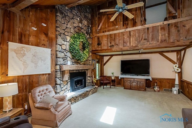 12949 Shaffer Rd, Swanton, OH 43558 - living area featuring a ceiling fan, wooden walls, carpet floors, a fireplace, and wainscoting
