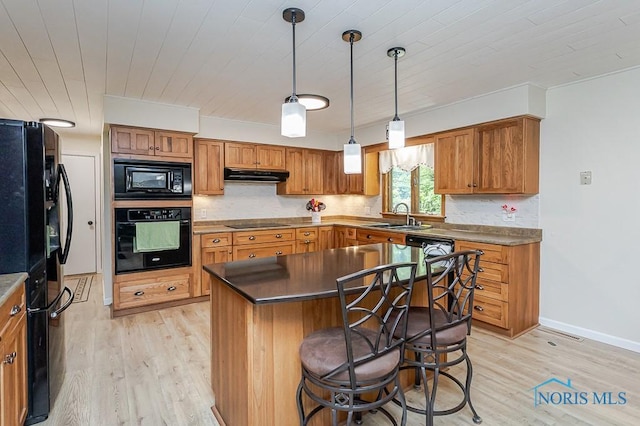 12949 Shaffer Rd, Swanton, OH 43558 - kitchen with black appliances, under cabinet range hood, a sink, light wood finished floors, and wood ceiling