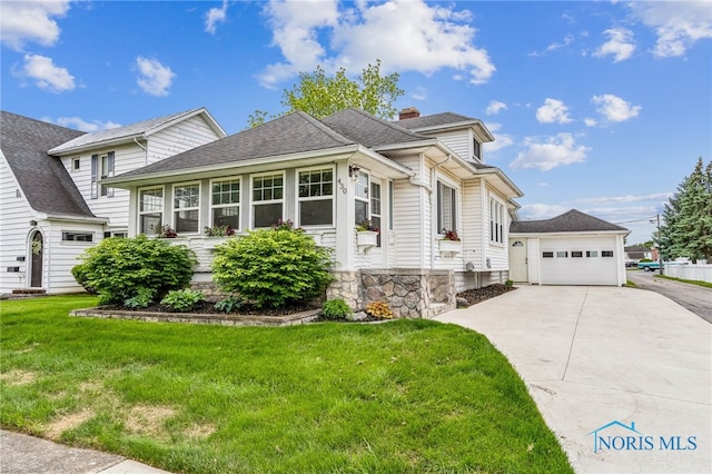 430 E 3rd St, Ottawa, OH 45875 - view of front of property featuring a garage, roof with shingles, a front lawn, an outbuilding, and a chimney