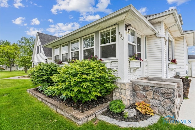 430 E 3rd St, Ottawa, OH 45875 - view of side of home featuring a yard and roof with shingles