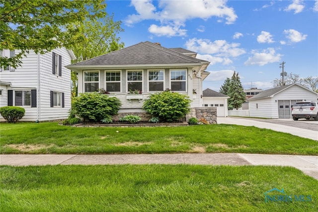 430 E 3rd St, Ottawa, OH 45875 - view of front facade featuring a garage, a front yard, and a shingled roof