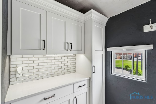 430 E 3rd St, Ottawa, OH 45875 - kitchen featuring decorative backsplash, light countertops, and white cabinets
