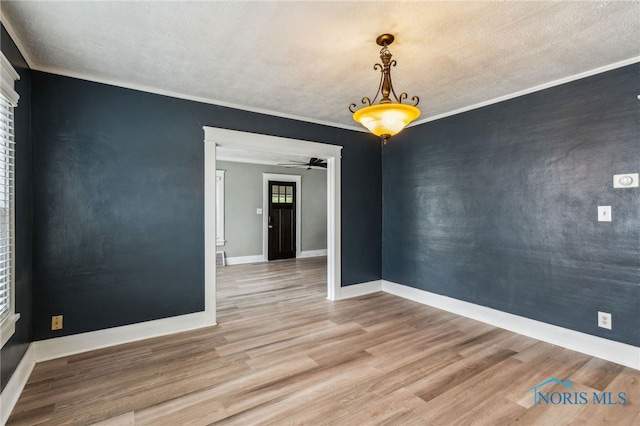 430 E 3rd St, Ottawa, OH 45875 - unfurnished room with wood finished floors, baseboards, crown molding, a textured ceiling, and ceiling fan