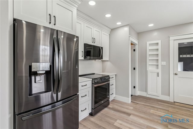 430 E 3rd St, Ottawa, OH 45875 - kitchen featuring appliances with stainless steel finishes, light wood finished floors, white cabinetry, light countertops, and baseboards