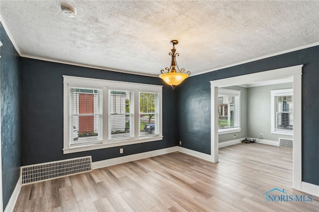 430 E 3rd St, Ottawa, OH 45875 - unfurnished room featuring a textured ceiling, wood finished floors, ornamental molding, baseboards, and a smoke detector