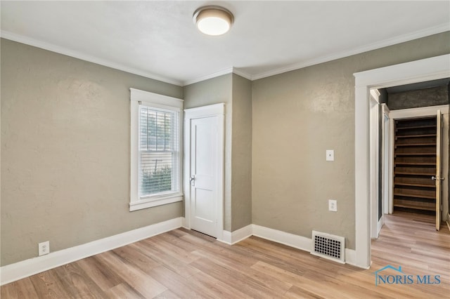 430 E 3rd St, Ottawa, OH 45875 - unfurnished bedroom with light wood-style flooring, baseboards, and ornamental molding
