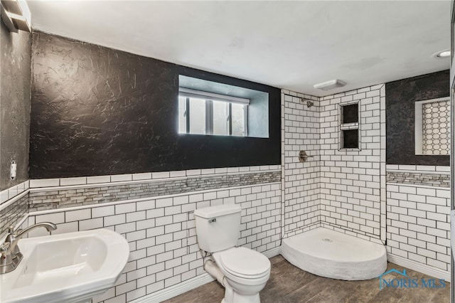 430 E 3rd St, Ottawa, OH 45875 - full bath featuring tile walls, a shower stall, a sink, toilet, and wood finished floors