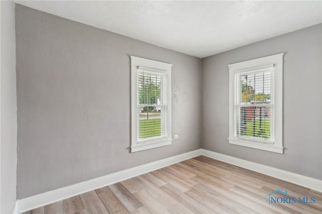 430 E 3rd St, Ottawa, OH 45875 - spare room featuring light wood-style flooring and baseboards