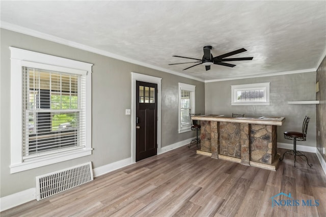 430 E 3rd St, Ottawa, OH 45875 - foyer featuring a dry bar, wood finished floors, plenty of natural light, baseboards, and ornamental molding
