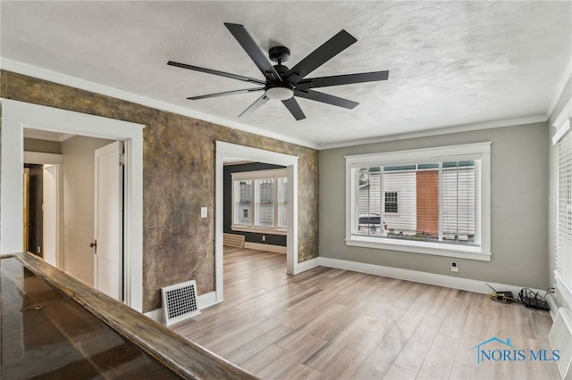 430 E 3rd St, Ottawa, OH 45875 - spare room with light wood-type flooring, baseboards, crown molding, and a ceiling fan