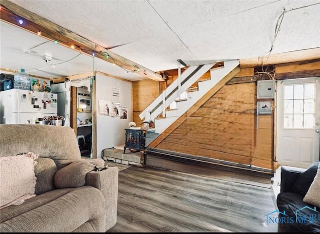 201 W Wabash St, Liberty Center, OH 43532 - living area featuring wood finished floors, stairs, electric panel, and a textured ceiling