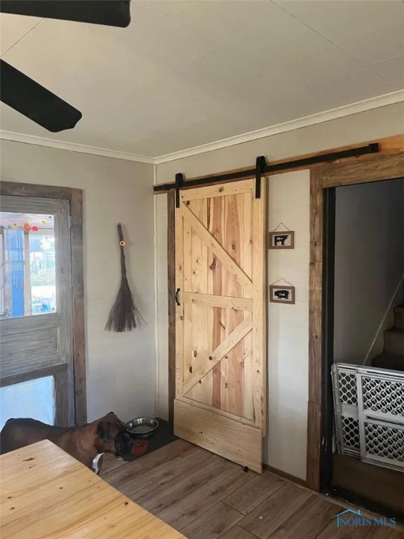 201 W Wabash St, Liberty Center, OH 43532 - entrance foyer with wood finished floors, crown molding, and a barn door