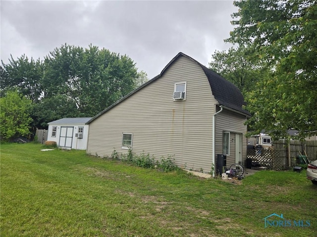 201 W Wabash St, Liberty Center, OH 43532 - view of home's exterior with an outbuilding, a gambrel roof, and a shingled roof