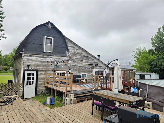 201 W Wabash St, Liberty Center, OH 43532 - wooden terrace featuring outdoor dining space and an outbuilding