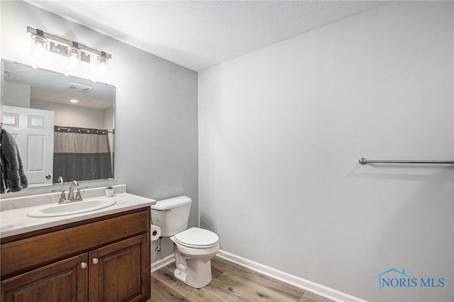 116 Wirth Ln, Sherwood, OH 43556 - bathroom featuring wood finished floors, toilet, vanity, baseboards, and a shower with curtain