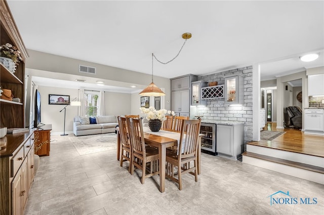 524 Sutton Pl, Findlay, OH 45840 - dining room featuring beverage cooler, a dry bar, and baseboards