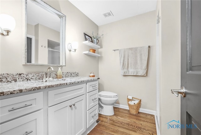 524 Sutton Pl, Findlay, OH 45840 - bathroom featuring vanity, toilet, wood finished floors, and baseboards