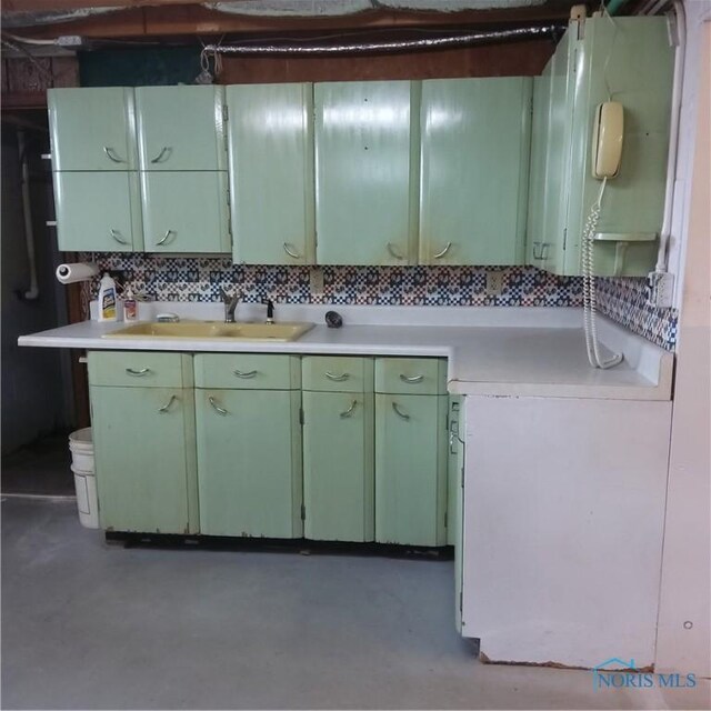 15979 Hill Rd, Defiance, OH 43512 - kitchen with a sink, green cabinetry, light countertops, and finished concrete flooring