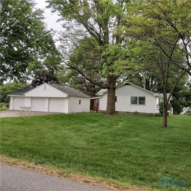 15979 Hill Rd, Defiance, OH 43512 - ranch-style home with a detached garage, an outdoor structure, and a front lawn